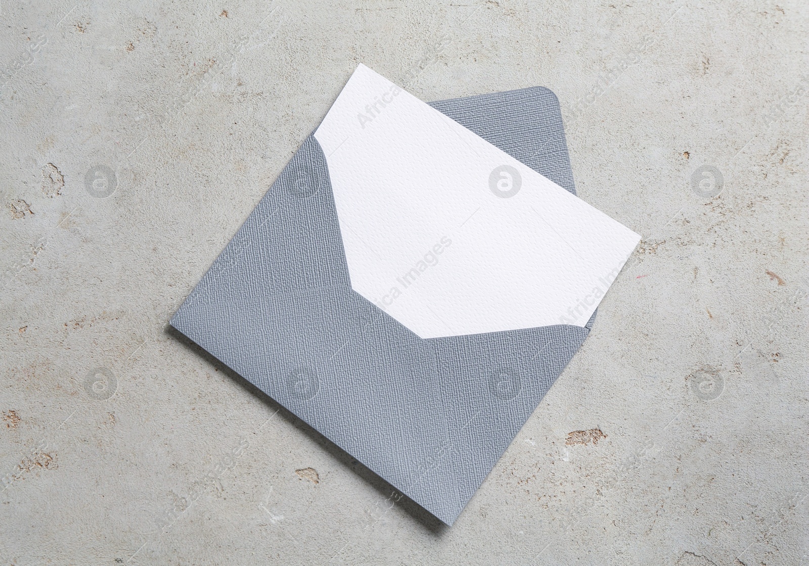 Blank invitation card and envelope on light grey table, top view. Space for design Photo of Blank invitation card and envelope on light grey table, top view. Space for design