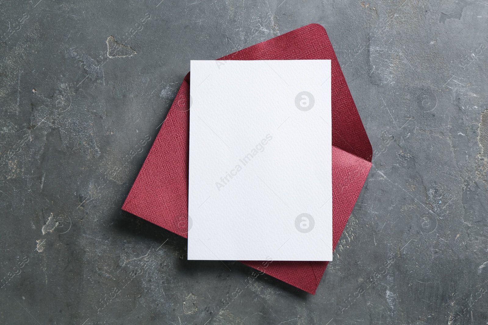 Blank invitation card and envelope on grey table, top view. Space for design Photo of Blank invitation card and envelope on grey table, top view. Space for design