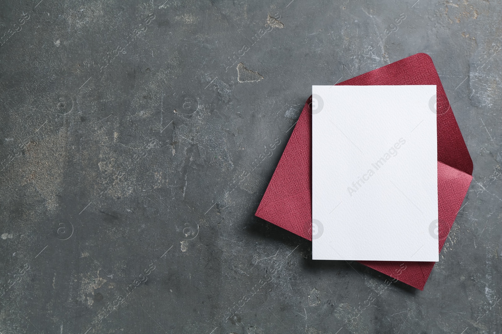 Blank invitation card and envelope on grey table, top view. Space for design Photo of Blank invitation card and envelope on grey table, top view. Space for design
