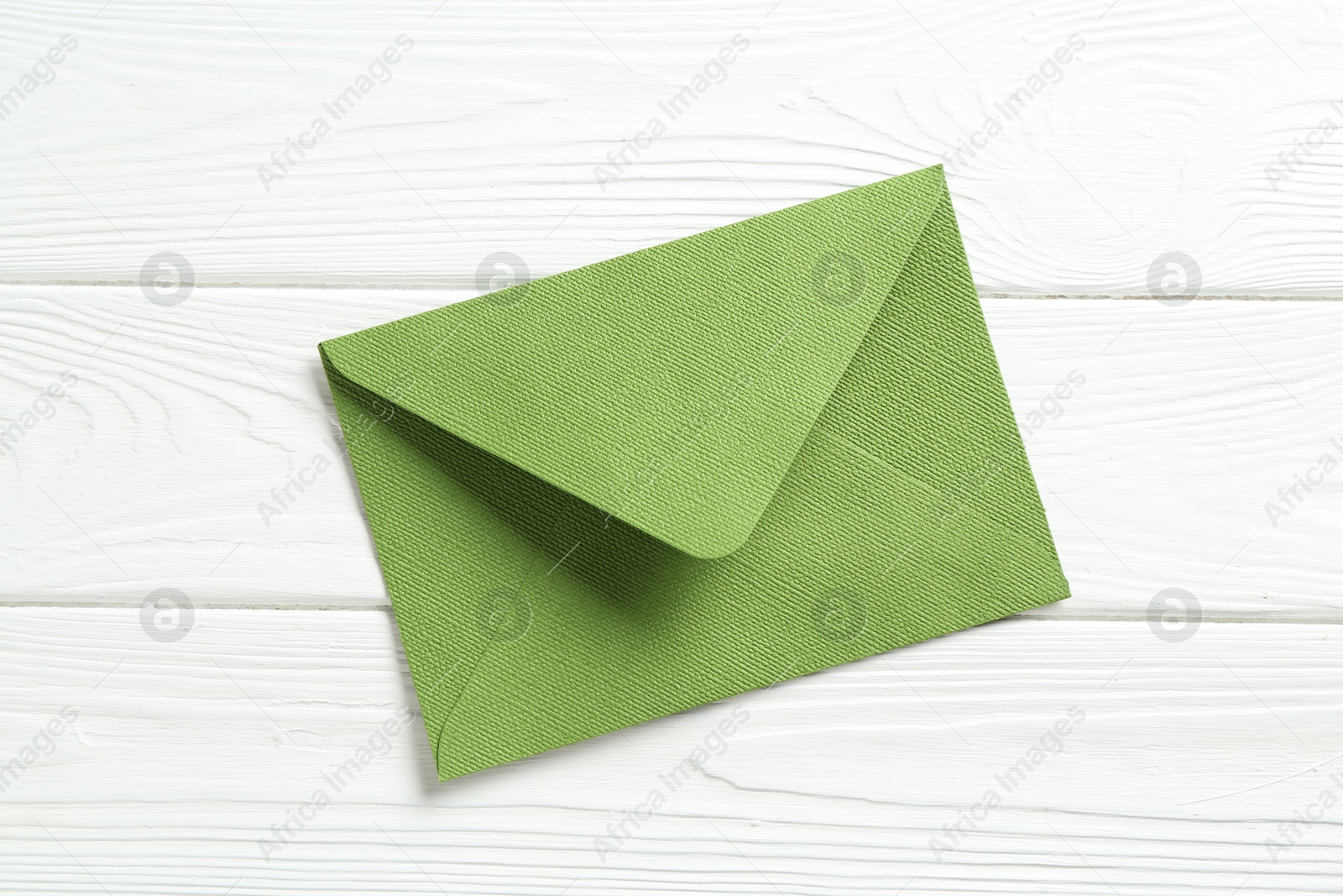Beautiful invitation envelope on white wooden table, top view Photo of Beautiful invitation envelope on white wooden table, top view