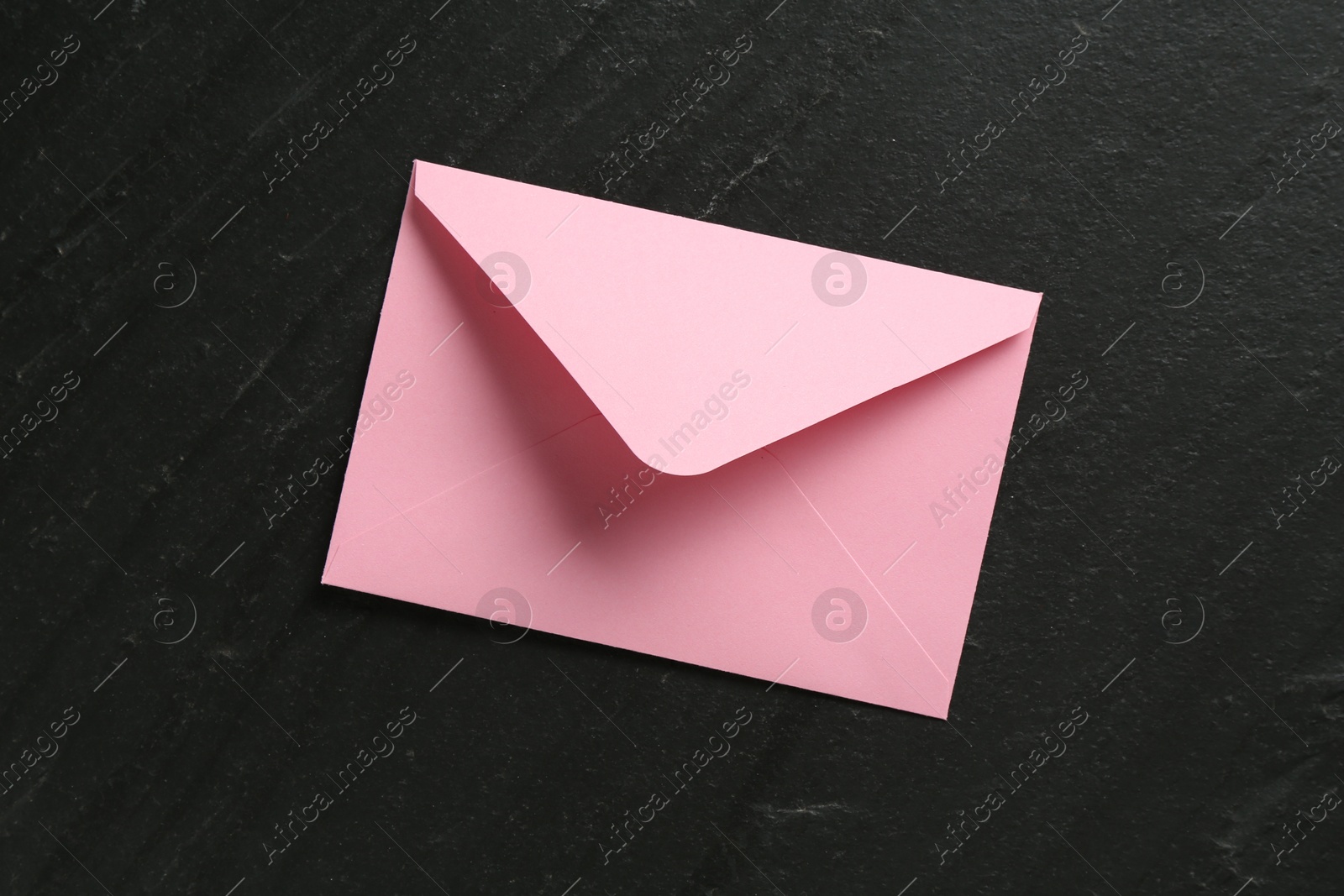 Beautiful invitation envelope on black table, top view Photo of Beautiful invitation envelope on black table, top view