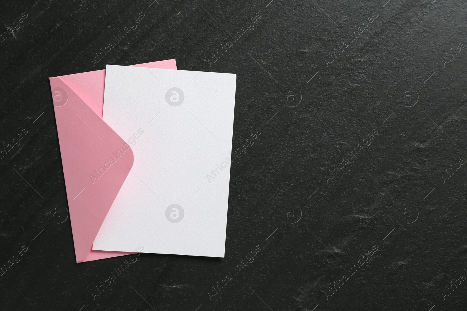 Blank invitation card and envelope on black table, top view. Space for design Photo of Blank invitation card and envelope on black table, top view. Space for design