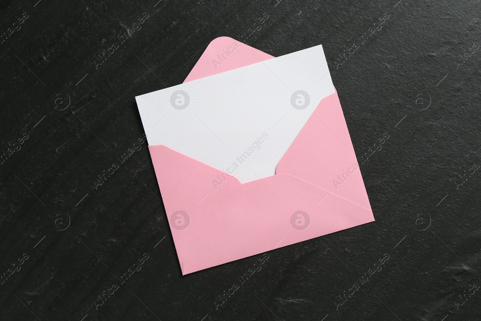 Blank invitation card and envelope on black table, top view. Space for design Photo of Blank invitation card and envelope on black table, top view. Space for design
