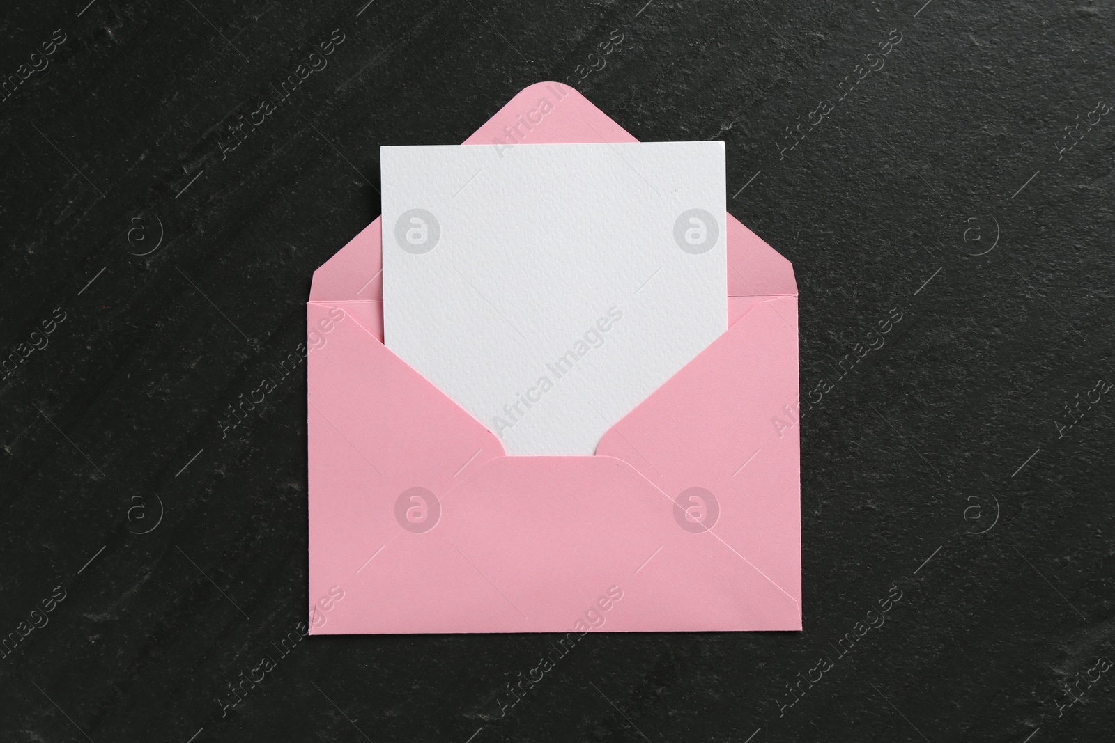 Blank invitation card and envelope on black table, top view. Space for design Photo of Blank invitation card and envelope on black table, top view. Space for design
