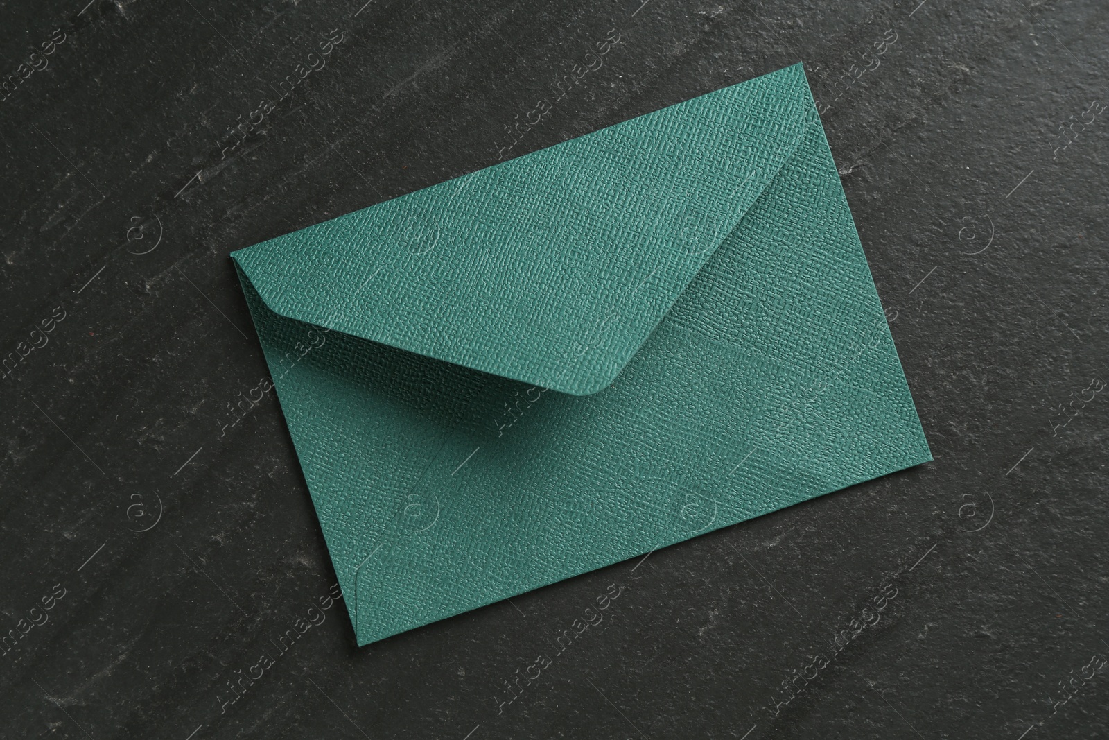 Beautiful invitation envelope on black table, top view Photo of Beautiful invitation envelope on black table, top view
