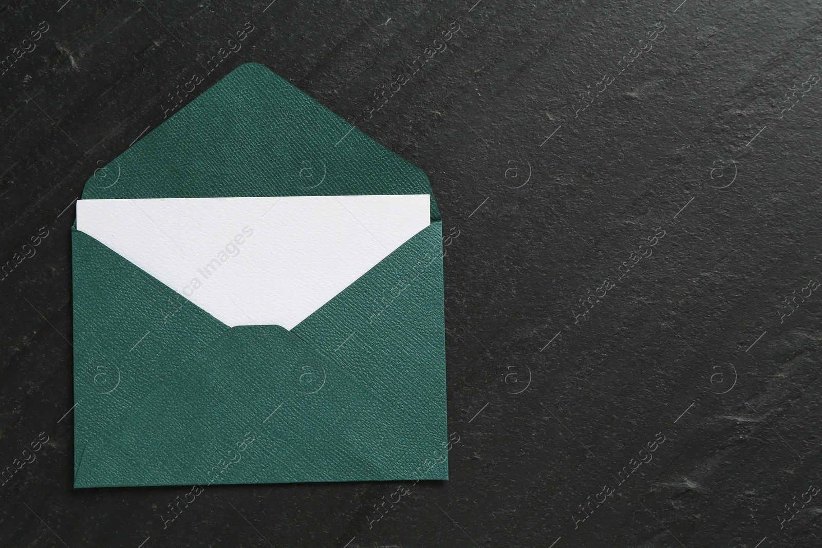 Blank invitation card and envelope on black table, top view. Space for text Photo of Blank invitation card and envelope on black table, top view. Space for text