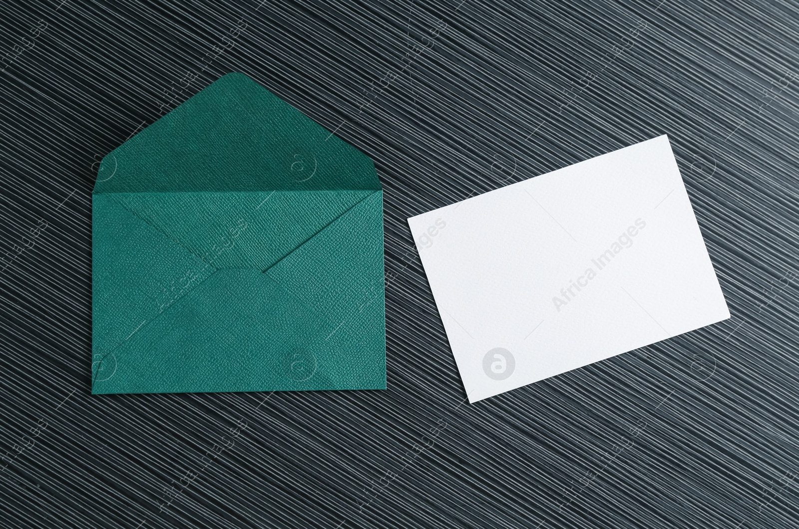Blank invitation card and envelope on black textured table, flat lay. Space for design Photo of Blank invitation card and envelope on black textured table, flat lay. Space for design