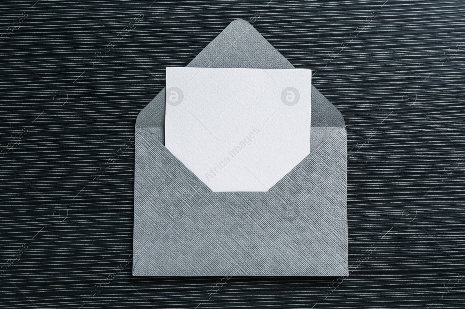 Blank invitation card and envelope on black textured table, top view. Space for design Photo of Blank invitation card and envelope on black textured table, top view. Space for design