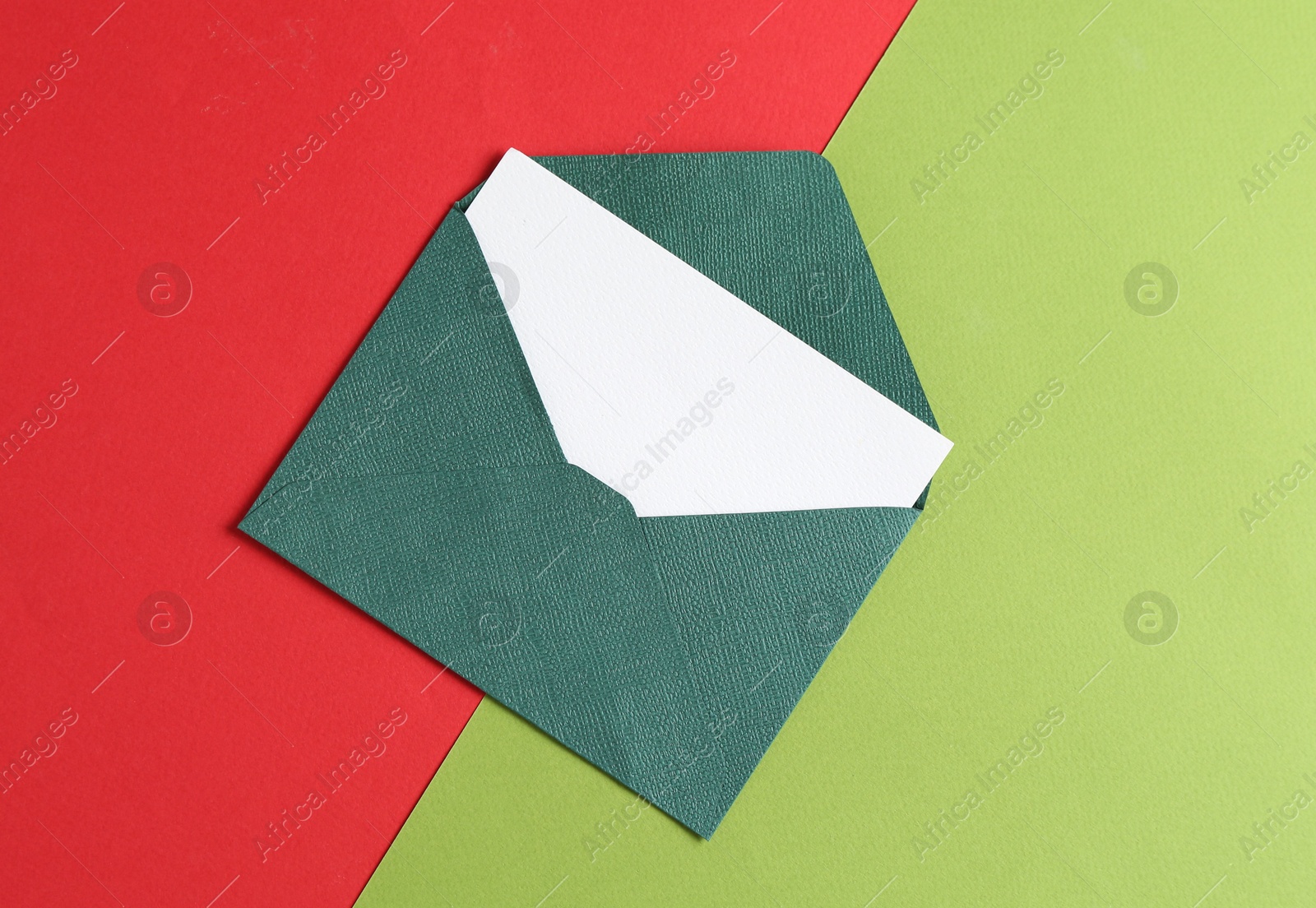 Blank invitation card and envelope on color background, top view Photo of Blank invitation card and envelope on color background, top view