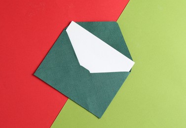 Photo of Blank invitation card and envelope on color background, top view
