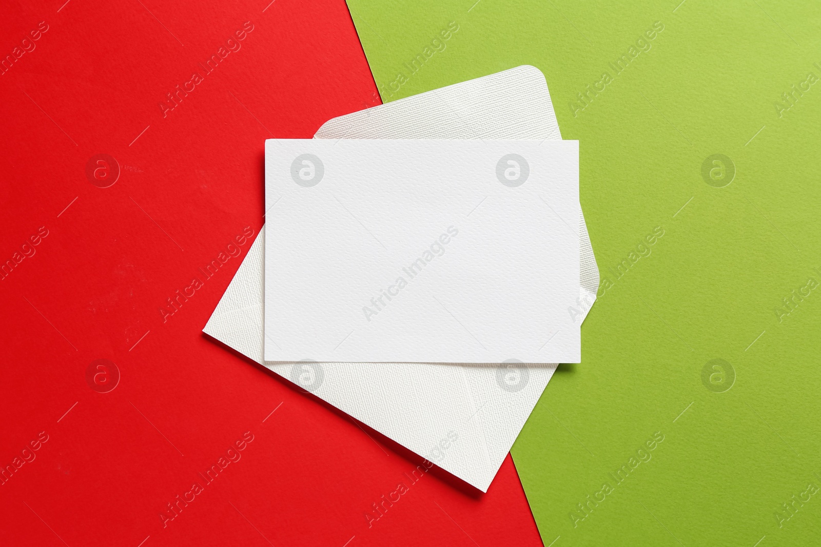 Blank invitation card and envelope on color background, top view. Space for design Photo of Blank invitation card and envelope on color background, top view. Space for design