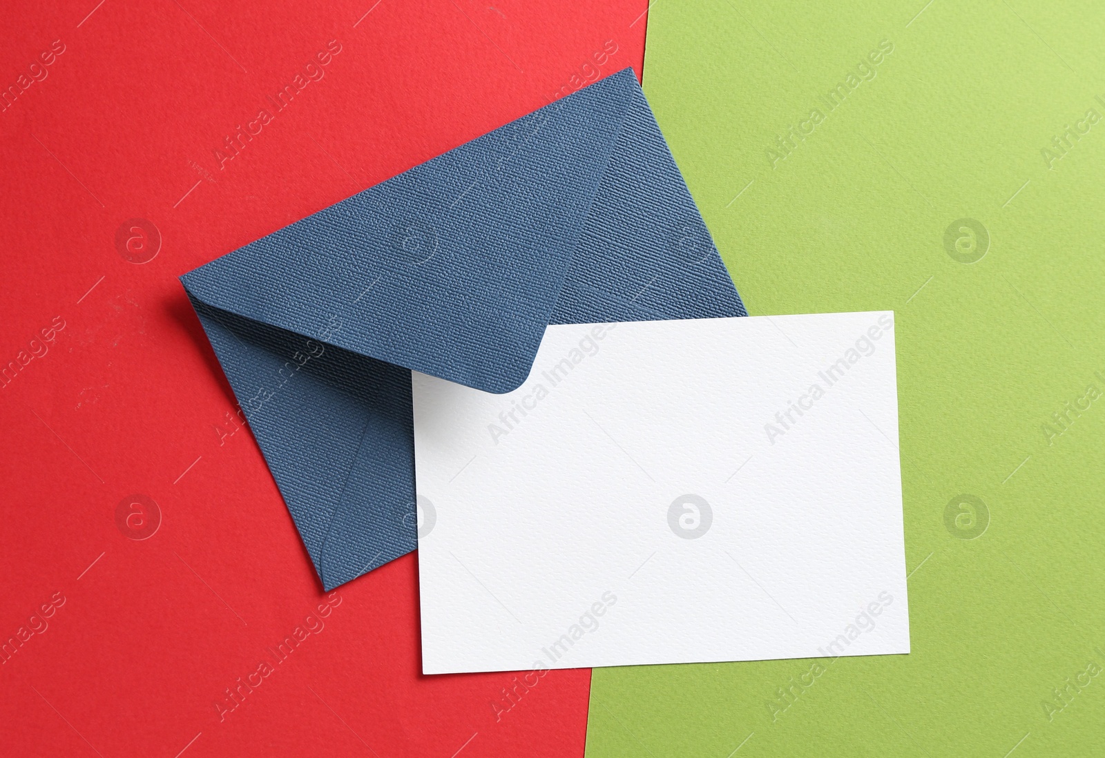 Blank invitation card and envelope on color background, top view. Space for design Photo of Blank invitation card and envelope on color background, top view. Space for design