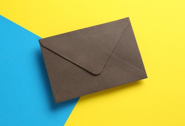 Photo of Beautiful invitation envelope on color background, top view