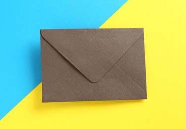 Photo of Beautiful invitation envelope on color background, top view