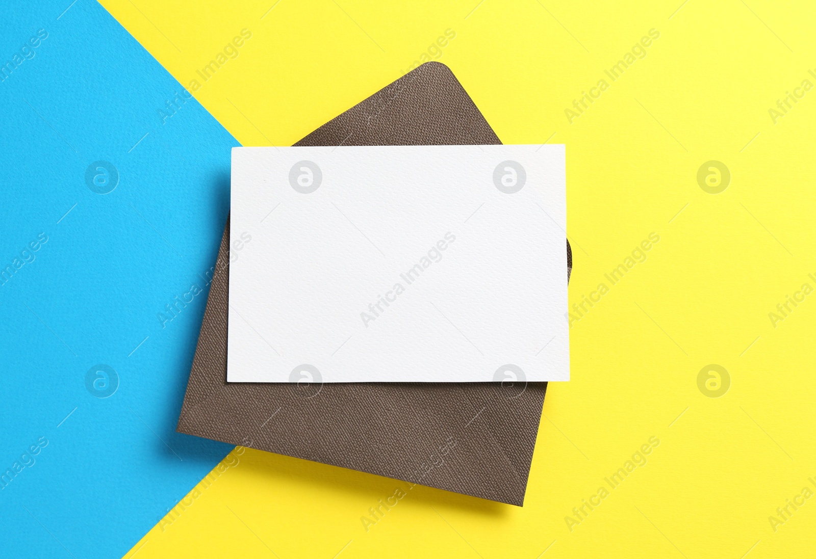 Blank invitation card and envelope on color background, top view. Space for design Photo of Blank invitation card and envelope on color background, top view. Space for design
