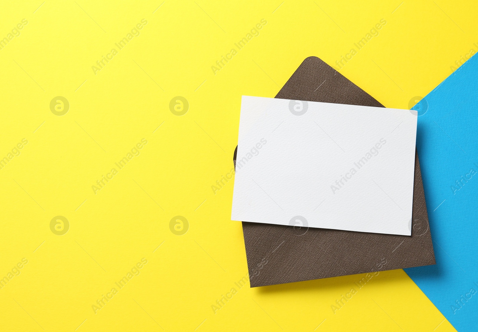 Blank invitation card and envelope on color background, top view. Space for design Photo of Blank invitation card and envelope on color background, top view. Space for design