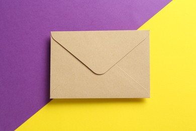 Photo of Beautiful invitation envelope on color background, top view