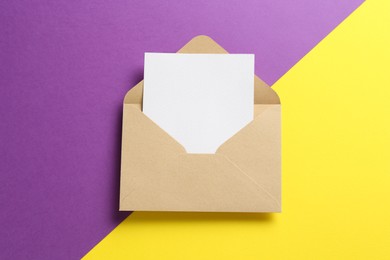 Photo of Blank invitation card and envelope on color background, top view. Space for design