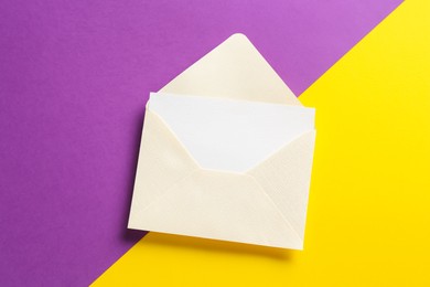 Photo of Blank invitation card and envelope on color background, top view