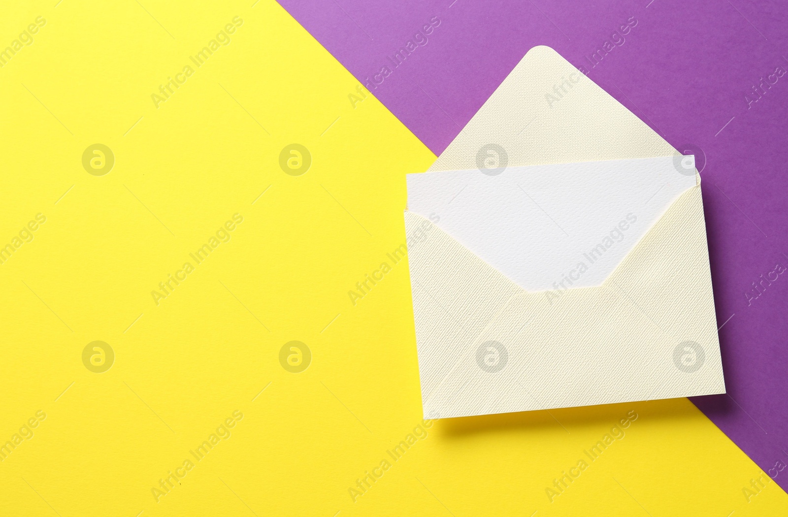 Blank invitation card and envelope on color background, top view Photo of Blank invitation card and envelope on color background, top view
