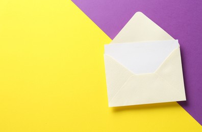 Photo of Blank invitation card and envelope on color background, top view