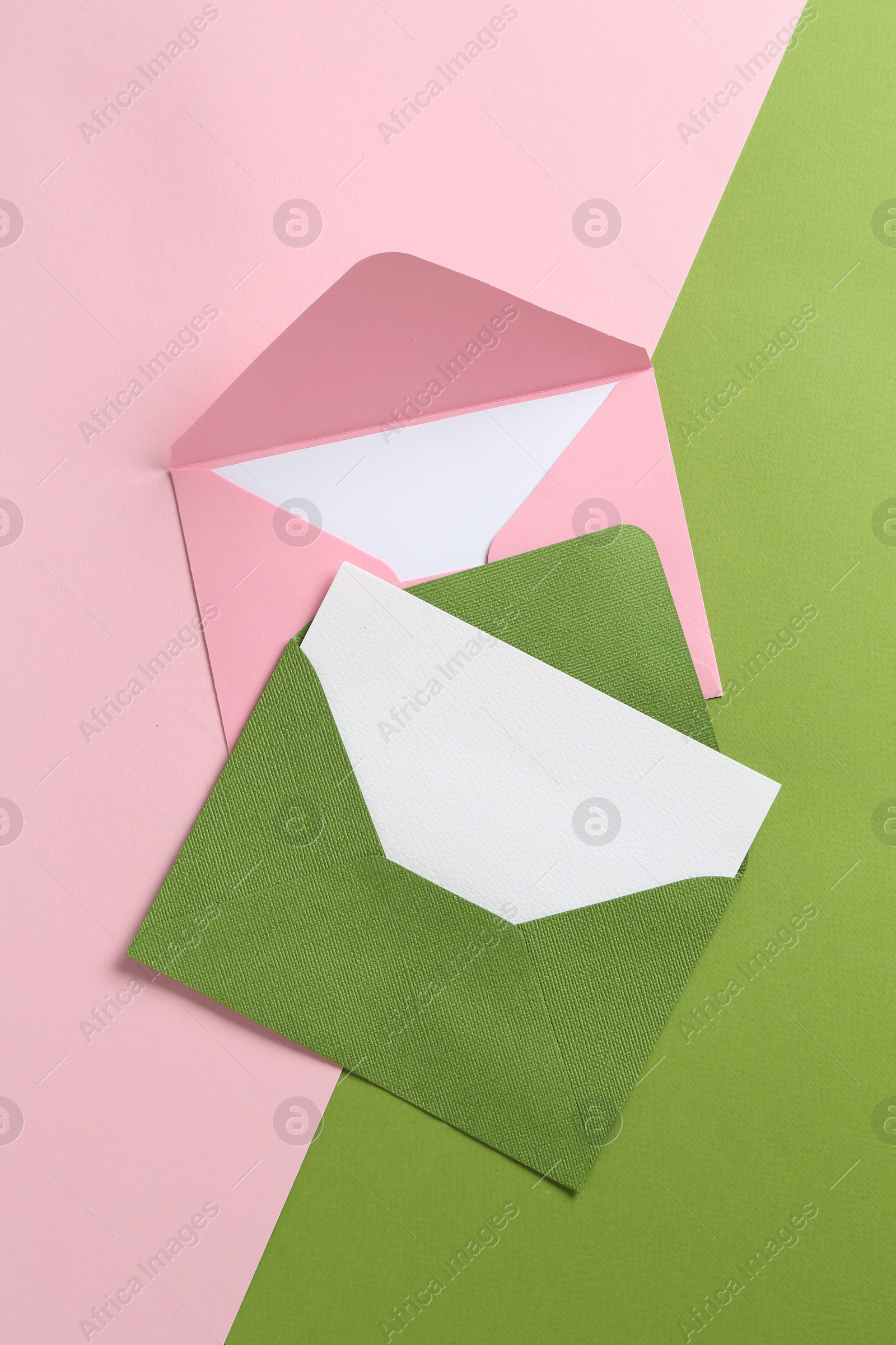 Blank invitation cards and envelopes on color background, flat lay Photo of Blank invitation cards and envelopes on color background, flat lay