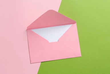 Photo of Blank invitation card and envelope on color background, top view