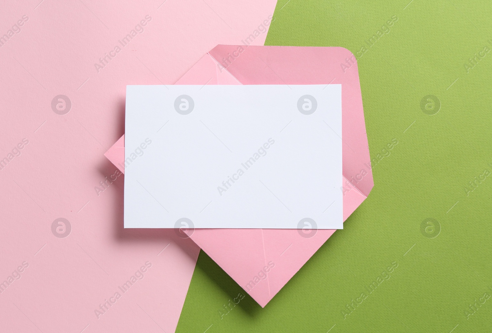 Blank invitation card and envelope on color background, top view. Space for design Photo of Blank invitation card and envelope on color background, top view. Space for design