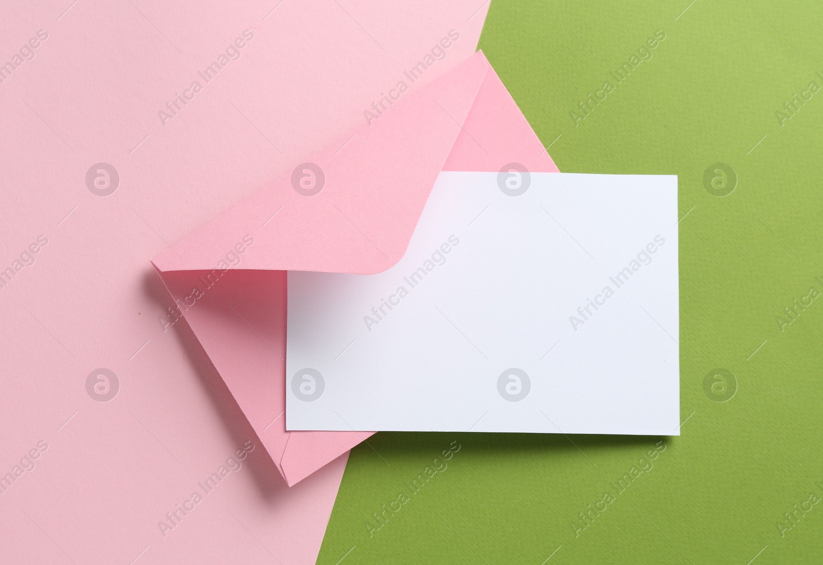 Blank invitation card and envelope on color background, top view. Space for design Photo of Blank invitation card and envelope on color background, top view. Space for design