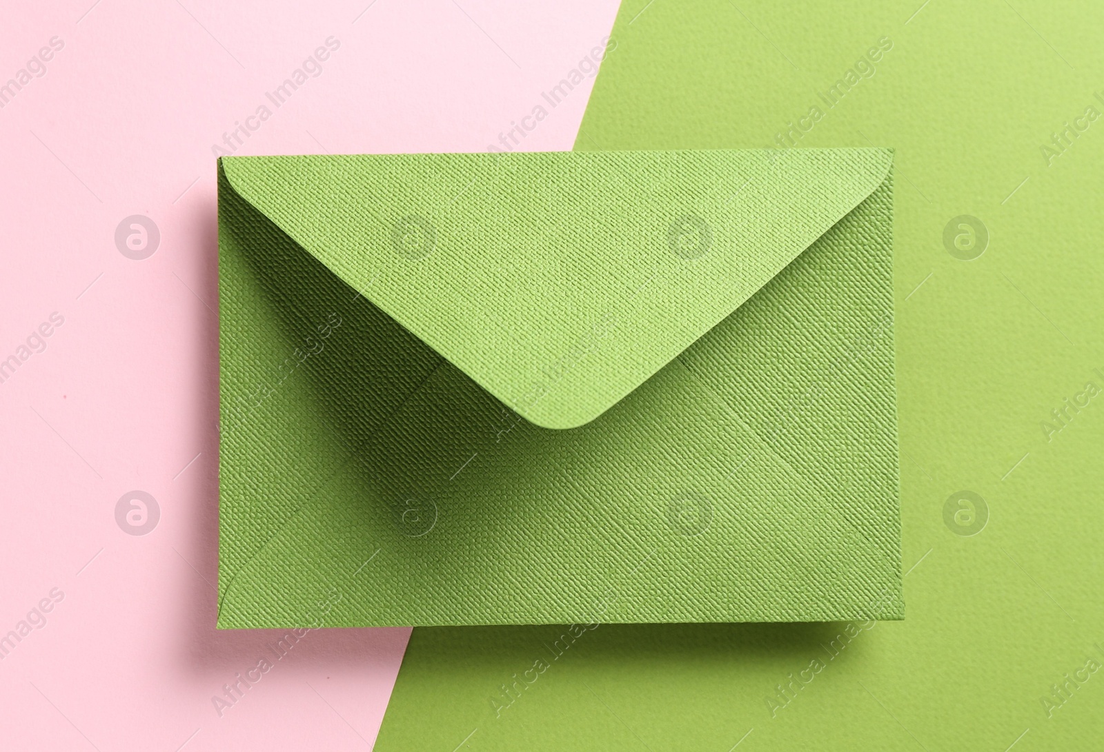 Beautiful invitation envelope on color background, top view Photo of Beautiful invitation envelope on color background, top view