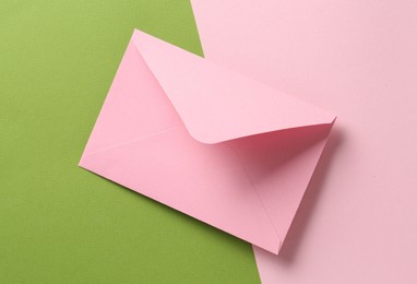 Photo of Beautiful invitation envelope on color background, top view