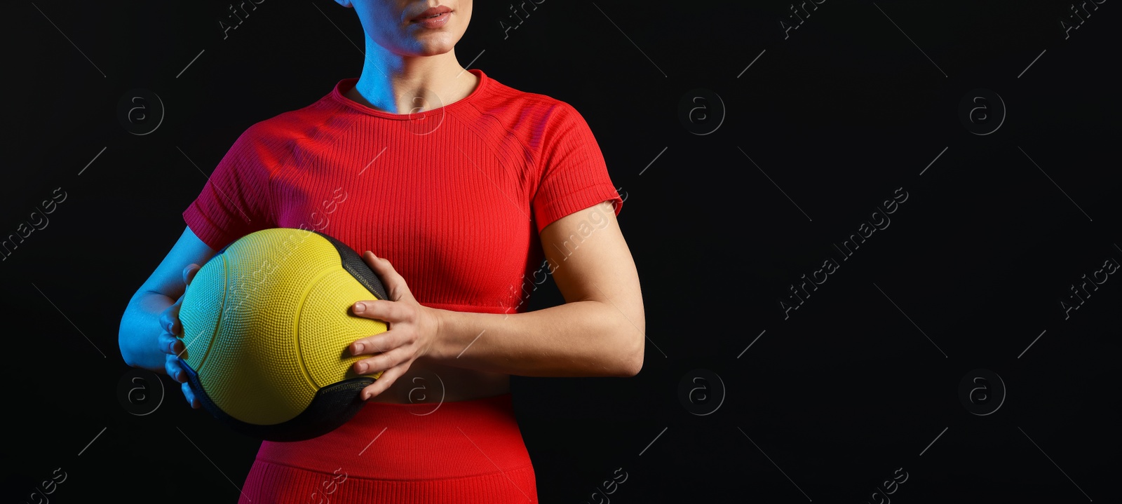 Woman with medicine ball on black background, closeup. Space for text Photo of Woman with medicine ball on black background, closeup. Space for text