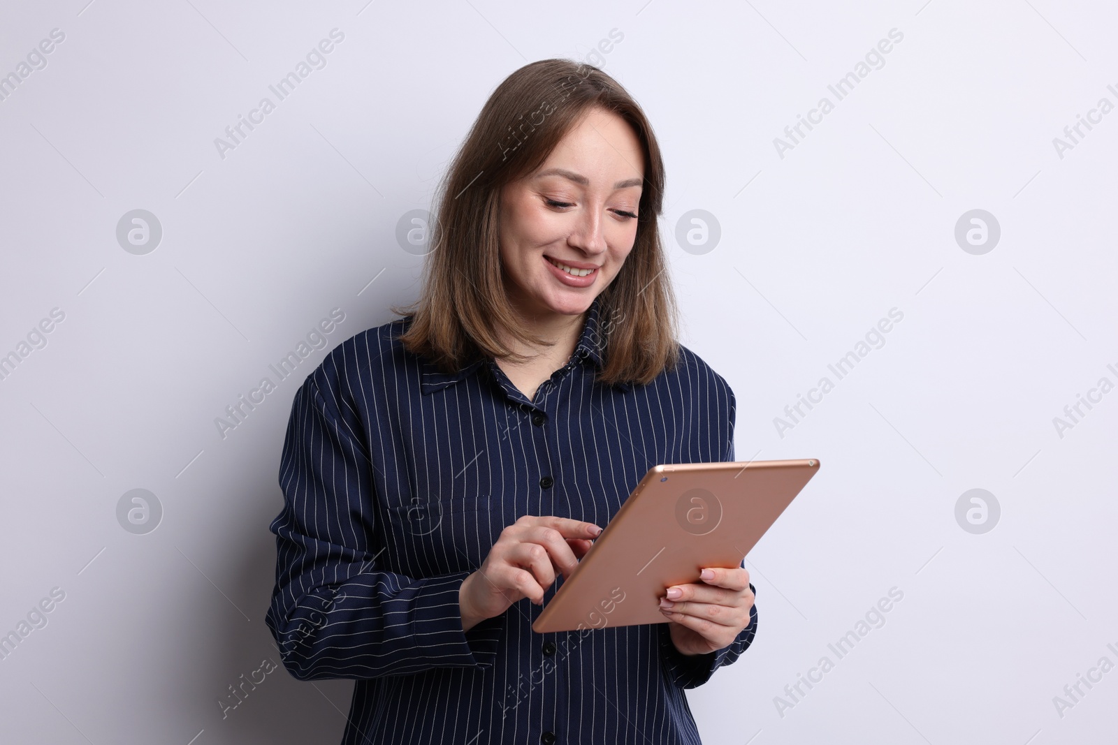 Woman with modern tablet on white background Photo of Woman with modern tablet on white background