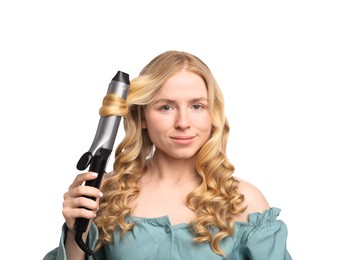 Photo of Woman curling her hair on white background