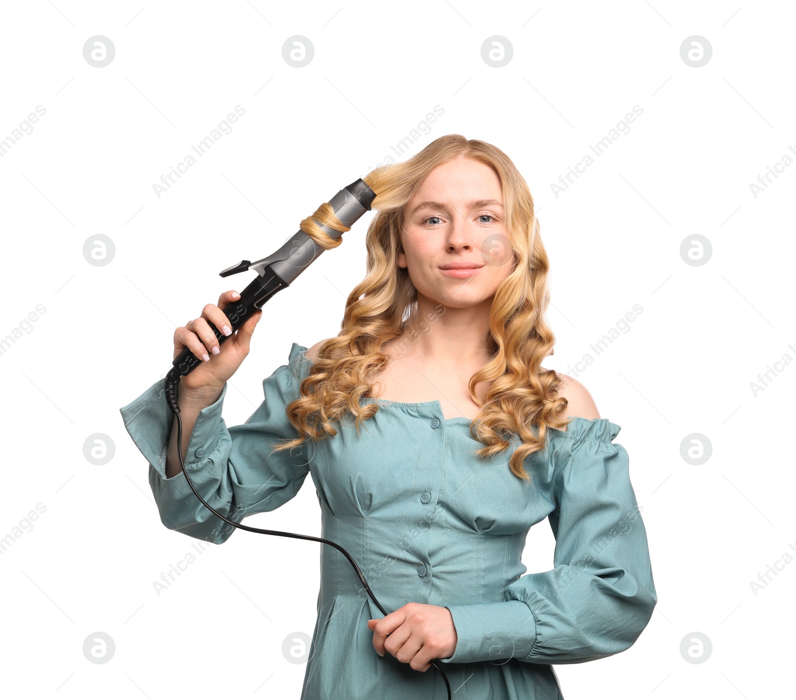 Photo of Woman curling her hair on white background