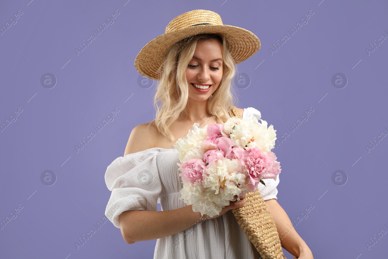 Happy woman with bouquet of beautiful peonies on purple background Photo of Happy woman with bouquet of beautiful peonies on purple background
