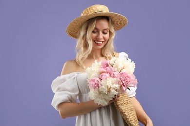 Photo of Happy woman with bouquet of beautiful peonies on purple background