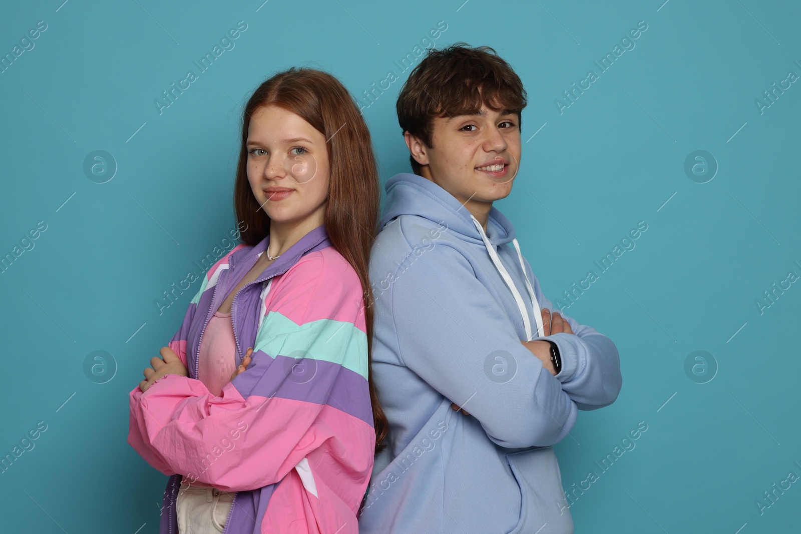 Photo of Teenage girl and boy on light blue background