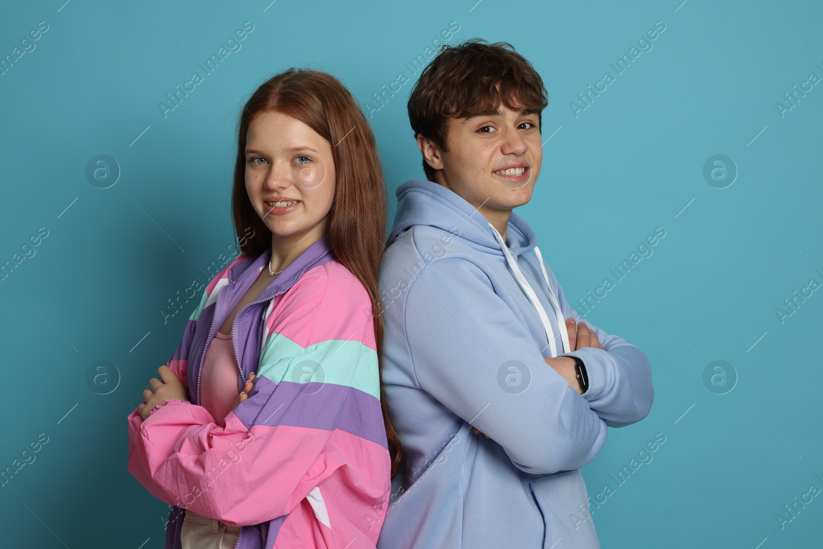 Photo of Teenage girl and boy on light blue background