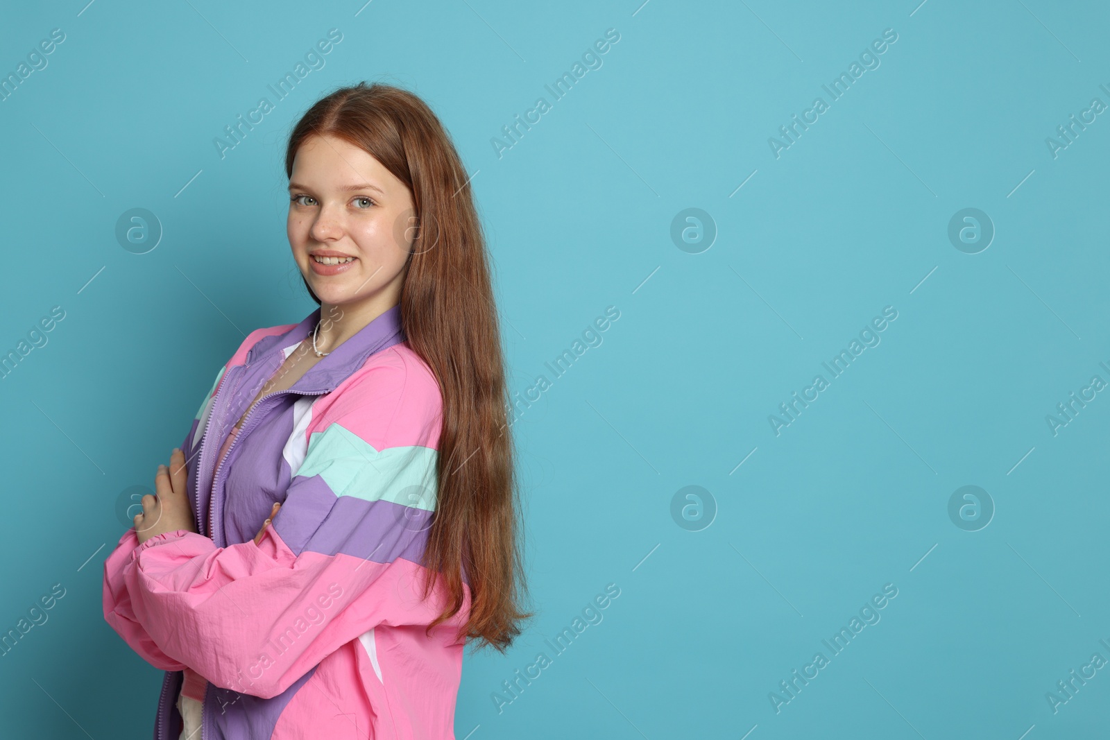 Portrait of teenage girl on light blue background. Space for text Photo of Portrait of teenage girl on light blue background. Space for text