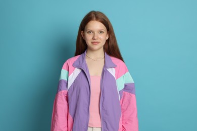Photo of Portrait of teenage girl on light blue background