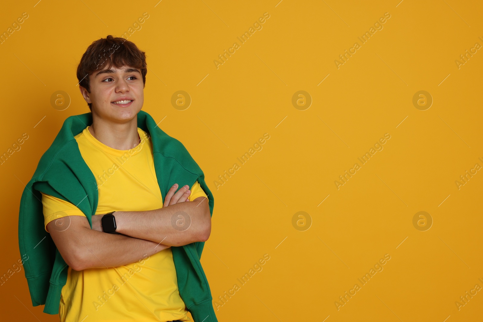 Portrait of teenage boy on yellow background. Space for text Photo of Portrait of teenage boy on yellow background. Space for text