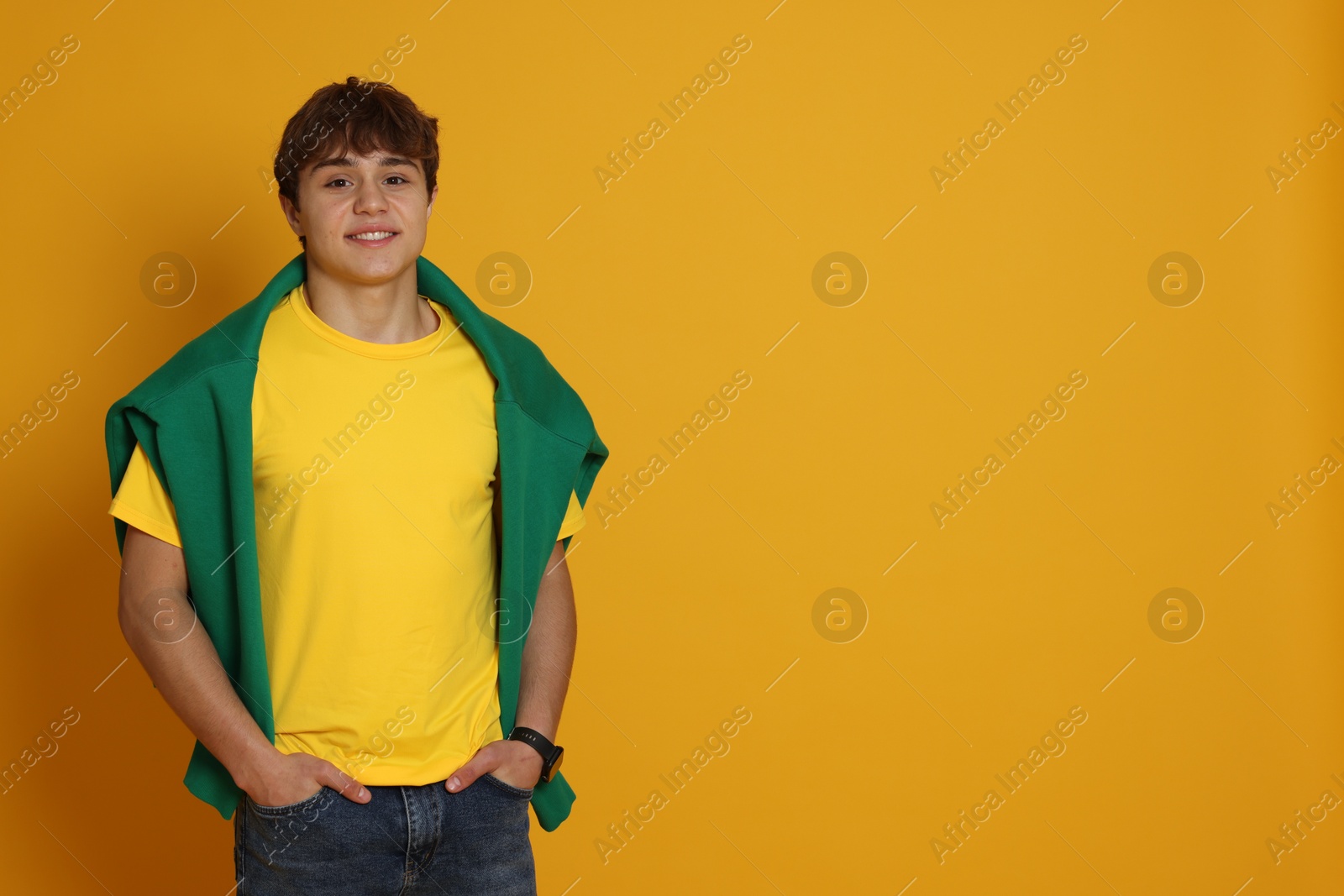 Portrait of teenage boy on yellow background. Space for text Photo of Portrait of teenage boy on yellow background. Space for text