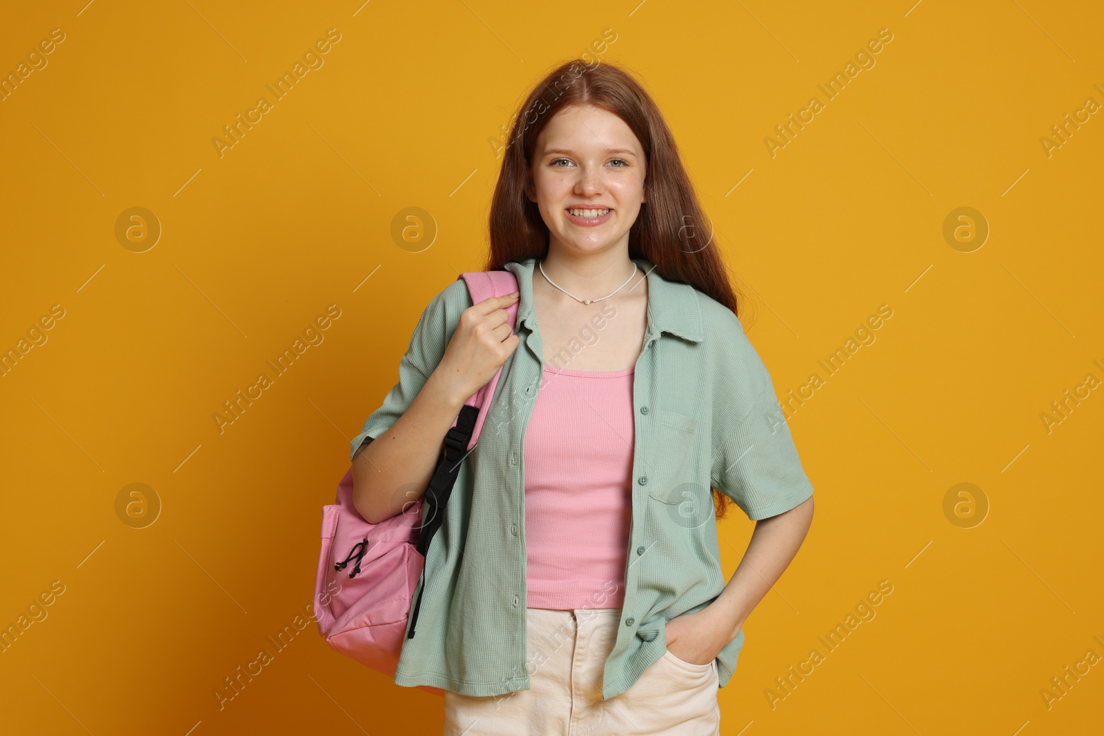Photo of Portrait of teenage girl on yellow background