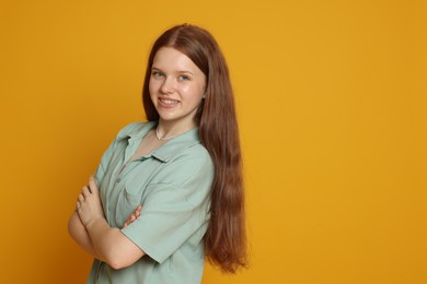 Photo of Portrait of teenage girl on yellow background. Space for text