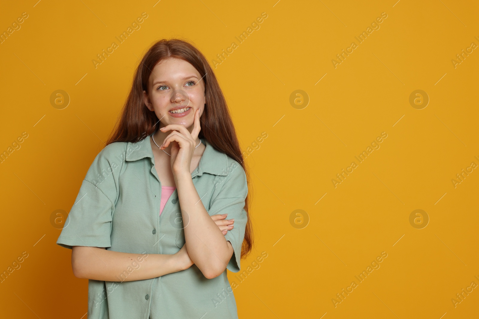 Photo of Portrait of teenage girl on yellow background. Space for text