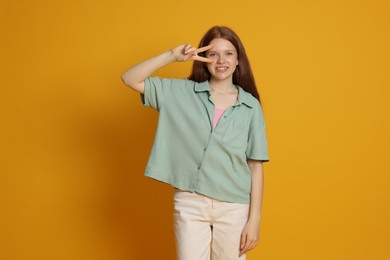 Photo of Portrait of teenage girl on yellow background