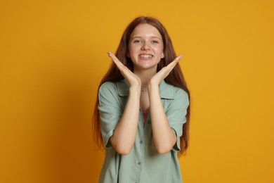 Photo of Portrait of teenage girl on yellow background