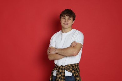 Photo of Portrait of teenage boy on red background