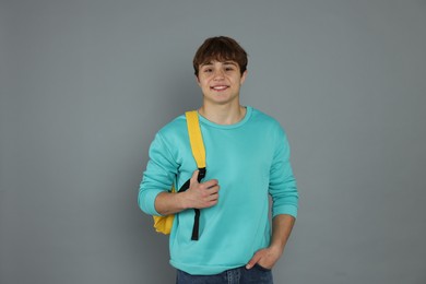 Photo of Portrait of teenage boy on grey background